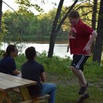 Campers sitting at picnic table