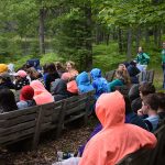 Campers listening to speaker