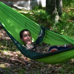 Boy making funny face in hammock