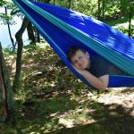 Male youth laying in hammock