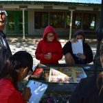 Children playing board games outside