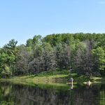 Wide shot of person on paddlebord