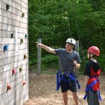 Instrutor telling kid how to rock climb