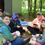 Goup of kids playing cards outside