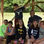 Camp group photo at picnic table
